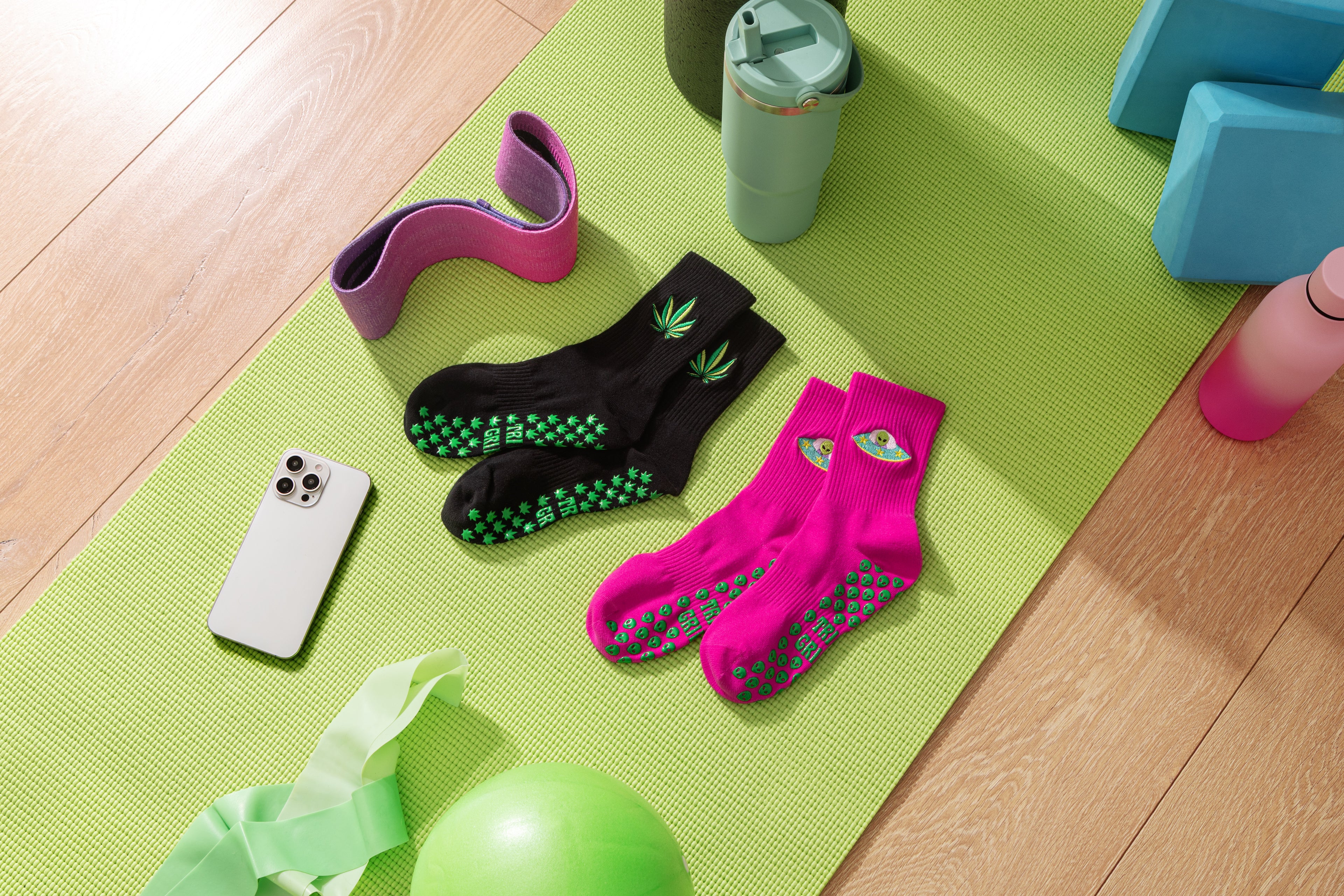 trippi grippi pilates grip socks on green yoga mat. Slip-resistant socks for pilates, barre, lagree or yoga.