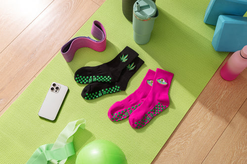 trippi grippi pilates grip socks on green yoga mat. Slip-resistant socks for pilates, barre, lagree or yoga.